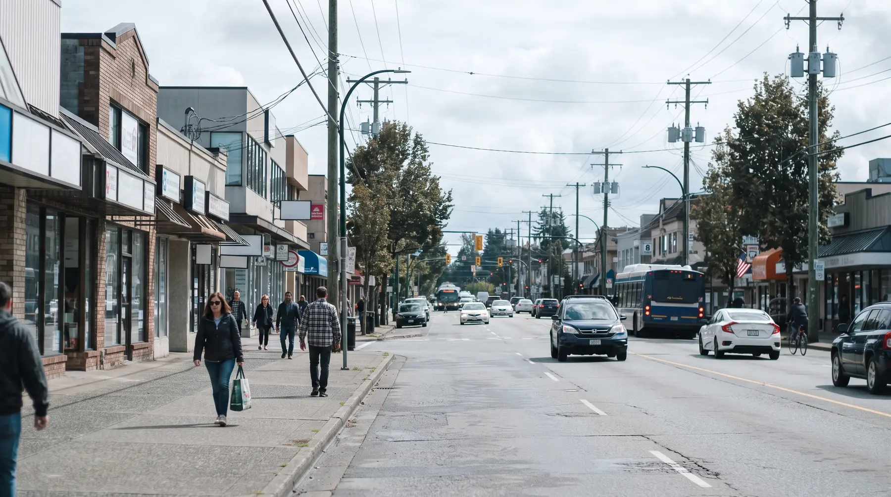 Commercial street with low-rise offices and shops along a busy road in North Delta